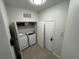 Functional laundry room with modern washer and dryer, convenient shelving, and ample storage space, keeping things organized at 2778 Almaton Loop # 302, Kissimmee, FL 34747