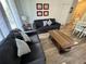 Comfortable living room with wood floors, gray couches, stylish decorations, and an open layout, perfect for relaxing and entertaining at 2778 Almaton Loop # 302, Kissimmee, FL 34747