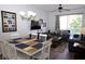 Cozy living room featuring a dining table, comfortable sofa, TV, and a balcony with natural light at 2778 Almaton Loop # 302, Kissimmee, FL 34747