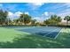 Tennis courts surrounded by trees with a green and blue surface, providing a recreational space at 2778 Almaton Loop # 302, Kissimmee, FL 34747