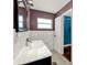 Bathroom featuring sleek vanity, sink, and a full mirror with white tile at 2809 Pioneer Rd, Orlando, FL 32808