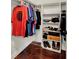 The closet has wood floors, built in shelves and hung clothes at 2809 Pioneer Rd, Orlando, FL 32808