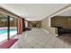 Spacious living room with fireplace and sliding door access to the pool area at 2809 Pioneer Rd, Orlando, FL 32808