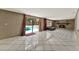 Living Room with fireplace, porcelain tile flooring, and pool views through sliding glass doors at 2809 Pioneer Rd, Orlando, FL 32808