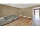 Open living room with wood-look floors and modern gray sofa at 2809 Pioneer Rd, Orlando, FL 32808
