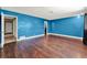 Living room featuring hardwood floors and blue painted walls at 2809 Pioneer Rd, Orlando, FL 32808