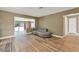 Cozy living room with modern gray sofa, wood-look flooring, and seamless access to the outdoors at 2809 Pioneer Rd, Orlando, FL 32808