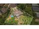 Aerial view highlighting property lines and a large wooded backyard with pool at 300 Hickory Ct, Apopka, FL 32712