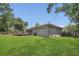 A house with a spacious backyard, a wood deck, a screened in patio, and mature trees at 300 Hickory Ct, Apopka, FL 32712