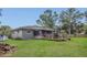 Spacious backyard with a pool, a deck, a screened in patio, and a gray exterior at 300 Hickory Ct, Apopka, FL 32712