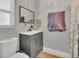 A clean bathroom with modern fixtures, gray vanity, a framed mirror, and a shower with a stylish curtain at 300 Hickory Ct, Apopka, FL 32712