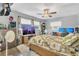Spacious bedroom with a ceiling fan, two windows, and wood-look floors at 300 Hickory Ct, Apopka, FL 32712