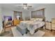 This bedroom has a ceiling fan, window with curtains and dresser and nightstand for storage at 300 Hickory Ct, Apopka, FL 32712