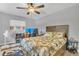 Cozy bedroom features a ceiling fan and wood-look floors at 300 Hickory Ct, Apopka, FL 32712