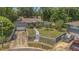 House exterior from an elevated angle, showing a lawn, a pool, mature trees, and a driveway at 300 Hickory Ct, Apopka, FL 32712