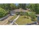 Charming home featuring a well-manicured lawn and garden with mature trees, offering a picturesque view at 300 Hickory Ct, Apopka, FL 32712