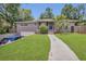 Inviting home with well-kept lawn, mature palm, and a convenient driveway, creating a charming curb appeal at 300 Hickory Ct, Apopka, FL 32712