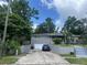 Charming one-story home with a brick exterior and a well-manicured front yard and long driveway at 300 Hickory Ct, Apopka, FL 32712