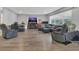 Spacious living room featuring wood floors, an electric fireplace, and cozy seating at 300 Hickory Ct, Apopka, FL 32712