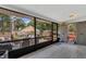 Enclosed porch features seating area, exterior storage, and access to wooden deck at 300 Hickory Ct, Apopka, FL 32712