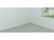A carpeted room features a window, creating a simple and bright space at 306 Wayland Dr, Haines City, FL 33844