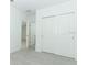 Bedroom with gray carpeting and a double door closet for ample storage space at 306 Wayland Dr, Haines City, FL 33844