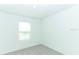Bedroom featuring neutral carpeting, a bright window, and a light-colored wall at 306 Wayland Dr, Haines City, FL 33844