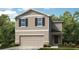 Charming two-story home featuring a two-car garage and a welcoming front porch at 306 Wayland Dr, Haines City, FL 33844