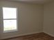 Bright bedroom featuring neutral walls, new flooring and a big window at 3156 Natoma Way, Orlando, FL 32825