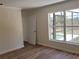 Bright bedroom featuring hardwood floors and a large window overlooking the pool at 3156 Natoma Way, Orlando, FL 32825
