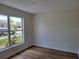 Bedroom featuring new, modern flooring and a large window at 3156 Natoma Way, Orlando, FL 32825