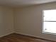 Bedroom featuring neutral walls, new flooring and a large window at 3156 Natoma Way, Orlando, FL 32825
