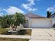 Charming one-story home with a well-manicured lawn and attached two-car garage at 3156 Natoma Way, Orlando, FL 32825
