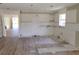 Spacious kitchen undergoing renovation with new flooring and partially tiled walls at 3156 Natoma Way, Orlando, FL 32825