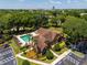 Aerial view of the community pool with lounge chairs, lush trees and city views at 325 Forestway Cir # 104, Altamonte Springs, FL 32701