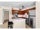 Modern kitchen featuring stainless steel appliances, wood cabinets, and a stylish island at 325 Forestway Cir # 104, Altamonte Springs, FL 32701