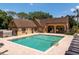 Exterior view of the community pool surrounded by lush landscaping and lounge seating at 325 Forestway Cir # 104, Altamonte Springs, FL 32701