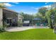 Backyard features a covered patio, hot tub, additional seating area and beautifully landscaped yard at 3400 Rose Mallow Loop, Oviedo, FL 32766
