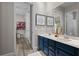 Bathroom with a double sink vanity with a modern blue finish and decor at 3400 Rose Mallow Loop, Oviedo, FL 32766