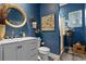 Elegant blue bathroom featuring a marble vanity, decorative accents, and a tiled shower at 3400 Rose Mallow Loop, Oviedo, FL 32766