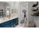 Bathroom with dual sinks, a large mirror, and a hallway leading to other rooms at 3400 Rose Mallow Loop, Oviedo, FL 32766