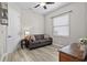 Bedroom with wood-style flooring, a gray sofa, a window with blinds, and a decorative lamp at 3400 Rose Mallow Loop, Oviedo, FL 32766