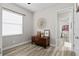 Bedroom featuring wood-style flooring, a window with blinds, and a decorative wood chest at 3400 Rose Mallow Loop, Oviedo, FL 32766