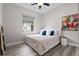 Bedroom with a ceiling fan, a window and a comfortable bed with accent pillows and an art piece at 3400 Rose Mallow Loop, Oviedo, FL 32766