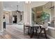 Cozy dining area with a dark wood table, lots of windows, and views of the outdoor patio at 3400 Rose Mallow Loop, Oviedo, FL 32766
