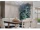 A dining room featuring a chandelier, a wood table, and an ornamental tree at 3400 Rose Mallow Loop, Oviedo, FL 32766