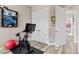 Home gym featuring spin bike, framed sports memorabilia, and bright natural light at 3400 Rose Mallow Loop, Oviedo, FL 32766