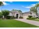 Beautiful single-Gathering home with a manicured lawn, brick driveway, and stone facade at 3400 Rose Mallow Loop, Oviedo, FL 32766