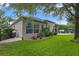 Exterior view of home showcasing well-maintained lawn, landscaping, and outdoor living space at 3400 Rose Mallow Loop, Oviedo, FL 32766