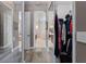 Bright hallway featuring wood-style floors, closet with mirrored doors and an arched entryway to the bathroom at 3400 Rose Mallow Loop, Oviedo, FL 32766